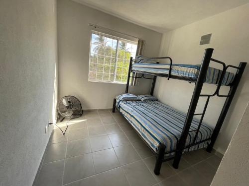 1 dormitorio con 2 literas y ventana en La Morada de Sofía en La Sabana