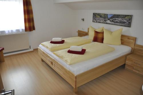 a bedroom with a large bed with two pillows on it at Flierelerhof in Arzl im Pitztal