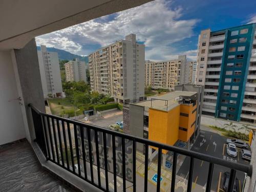 a balcony with a view of a city with buildings at Bello apartaestudio Alto Living in Cali