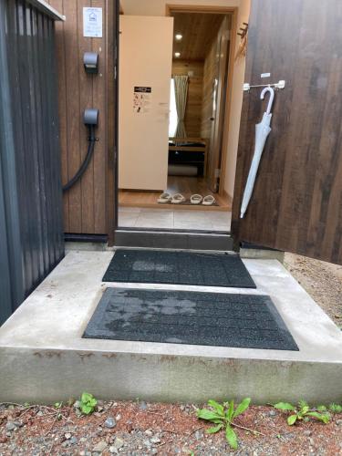 an open door to a bathroom with a shower at はるの空 in Biei