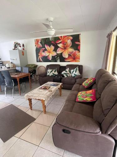 a living room with a couch and a table at The Sundown Lodges Rarotonga in Arorangi
