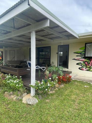 a pergola on the side of a house at The Sundown Lodges Rarotonga in Arorangi