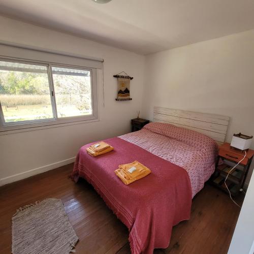 a bedroom with a bed with two towels on it at Ensueño casa de isla in Tigre