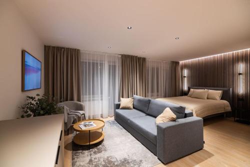 a living room with a couch and a bed at Birzes dzīvoklis (Birzes condo) in Cēsis