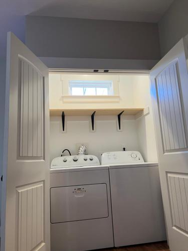 a small kitchen with two sinks and a window at Relaxing House at Downtown Chattanooga in Chattanooga