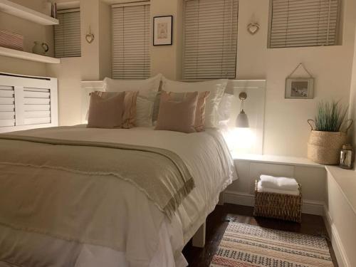 a bedroom with a large bed with white sheets and pillows at Abbey and Clock Tower view in St. Albans