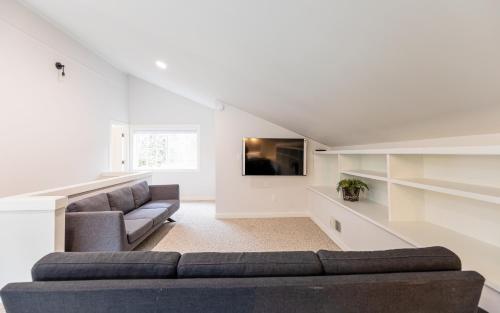 a living room with a couch and a tv at Riverside Retreat on Skagit River in Concrete