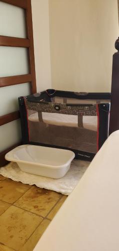 an open suitcase sitting on the floor next to a counter at Mangos Villas - Chiara in Kilifi