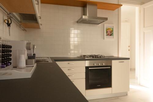 a kitchen with a black and white stove top oven at Civico89 in Pescara