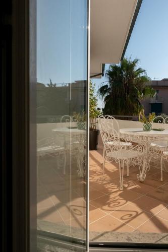 a glass door with a table and chairs on a patio at Civico89 in Pescara