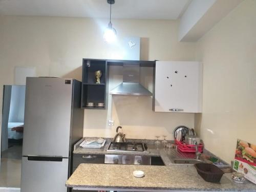 a kitchen with a refrigerator and a sink at Booking house in Agadir