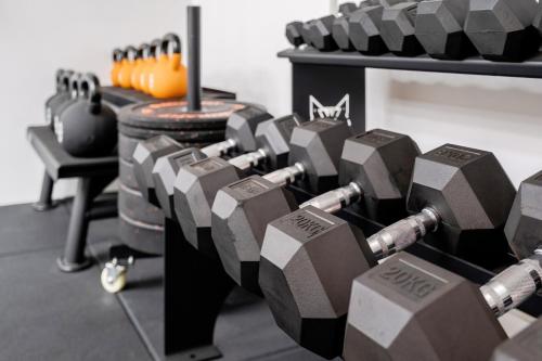a bunch of dumbbells are lined up in a gym at Luxury Central Mayfair Townhouse with AC 3BR 3BA in London
