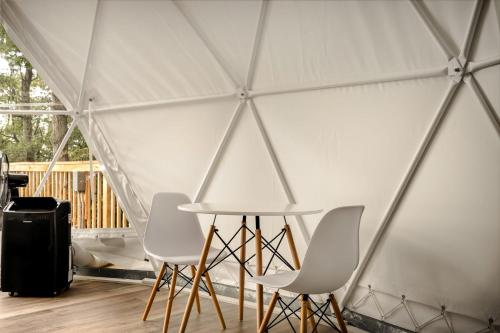 a group of chairs and a table in a tent at Luxe Dome w Hot Tub, Full Bath & Mountain View in Augusta