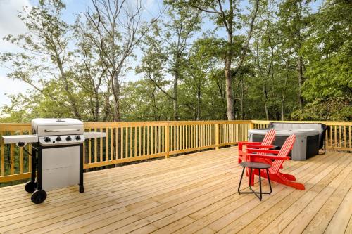 a deck with a grill and red chairs on it at Luxe Dome w Hot Tub, Full Bath & Mountain View in Augusta