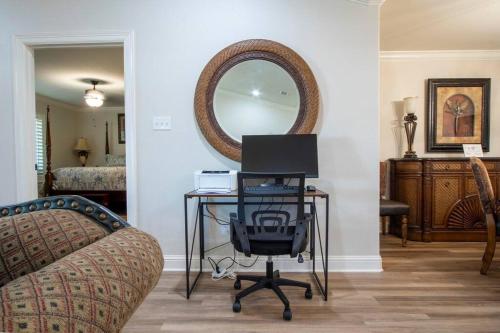 a room with a desk with a chair and a mirror at Retreat at Premier Parks in Longview