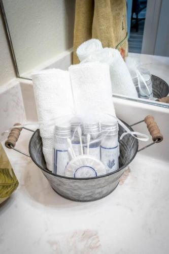 a bowl filled with toiletries on a counter in front of a mirror at Retreat at Premier Parks in Longview