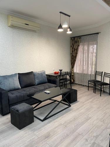 a living room with a couch and a table at ByurHouse in Byurakan