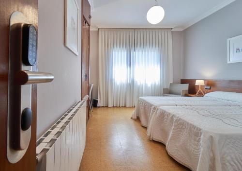 Ένα ή περισσότερα κρεβάτια σε δωμάτιο στο Hotel Prado Viejo