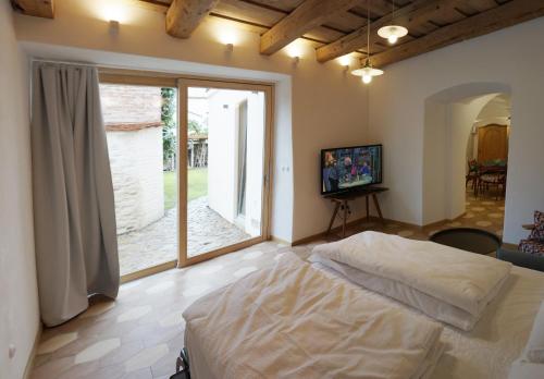 a bedroom with a large bed and a large window at Old Town Flat with Private Patio in Kutná Hora