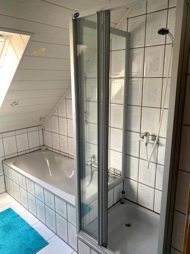 a bathroom with a bath tub in a attic at Ferienwohnung Klara in Meßstetten