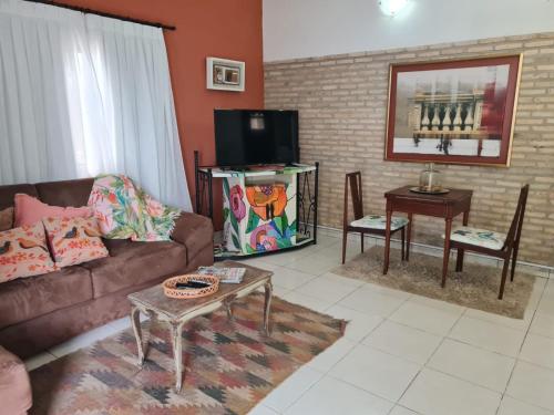 a living room with a couch and a tv at La Pinta Hotel Boutique in San Bernardino