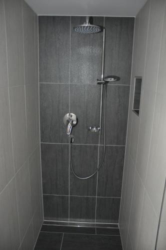 a shower with a shower head in a bathroom at Flierelerhof in Arzl im Pitztal