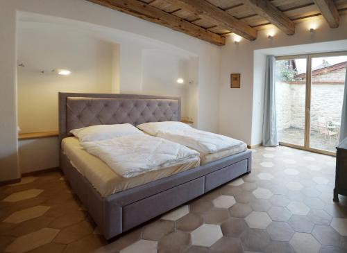 a bedroom with a bed in a room with a window at Old Town Flat with Private Patio in Kutná Hora