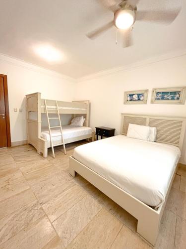a bedroom with two beds and a ladder in it at Xeliter Balcones del Atlantico - Las Terrenas in Las Terrenas