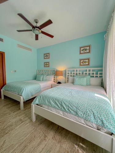 a bedroom with two beds and a ceiling fan at Xeliter Balcones del Atlantico - Las Terrenas in Las Terrenas