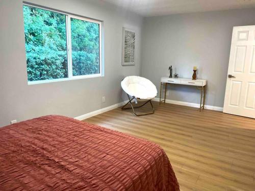 a bedroom with a bed and a desk and a window at Spacious & Modern 4B3B house in Pasadena in Pasadena