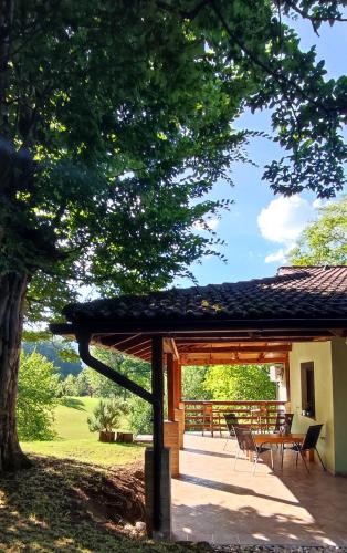 a pavilion with a table and chairs under a tree at Private place, Boca in Bihać