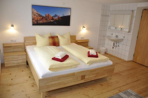 a bedroom with a bed with two red towels at Flierelerhof in Arzl im Pitztal