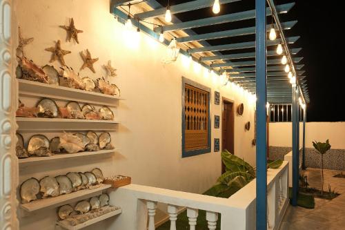 a room with shelves of shells on the wall at Salem Fish Guest House in Al Ḩadd