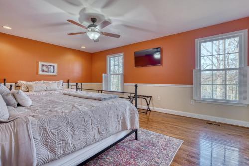 a bedroom with orange walls and a bed and a ceiling fan at 8-Bedroom Luxury Home in Baltimore Maryland in Phoenix