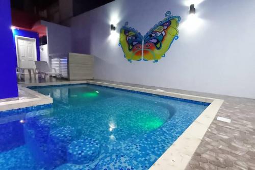 a swimming pool with a butterfly on the wall at Condos Frida in Cozumel