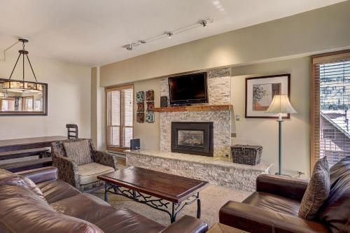 a living room with a couch and a fireplace at Superior Apartment with Sauna in Breckenridge