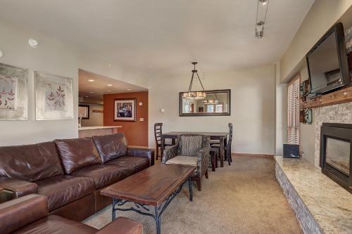 a living room with a couch and a table at Superior Apartment with Sauna in Breckenridge