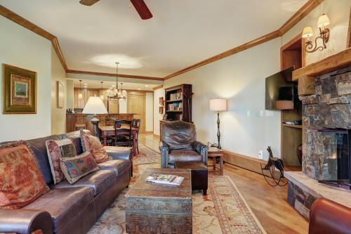 a living room with a couch and a fireplace at Luxurious 2 Bedroom Condo 50 Feet From The Slopes! condo in Beaver Creek
