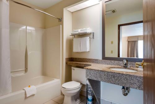 a bathroom with a sink and a toilet and a bath tub at Best Western Spooner Riverplace in Shell Lake