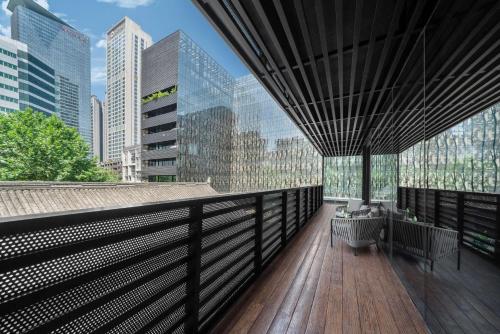 a balcony with a view of a city skyline at The Temple House in Chengdu