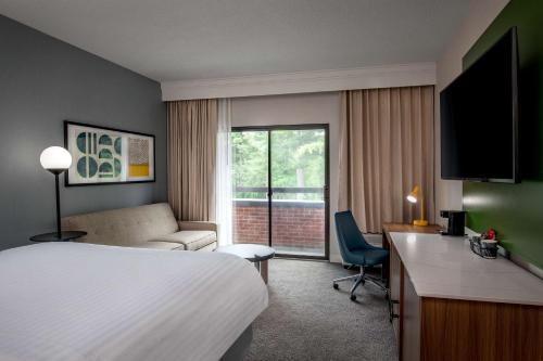 a hotel room with a bed and a desk at Sonesta Select Boston Foxborough Mansfield in Foxborough