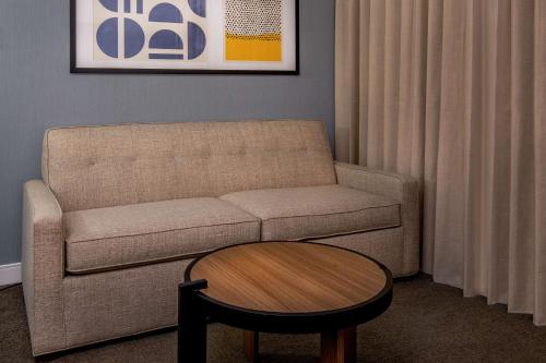 a living room with a couch and a table at Sonesta Select Boston Foxborough Mansfield in Foxborough
