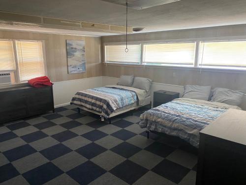 a bedroom with two beds and a checkered floor at Spacious 4 Bedroom Home with 5 Beds near Interstate 40 in Amarillo, TX in Amarillo