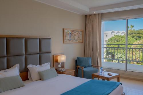 a hotel room with a bed and a window at Hotel Bel Azur Thalasso & Bungalows in Hammamet