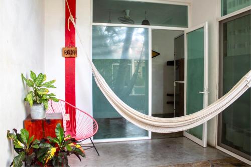 a hammock hanging from the side of a house at Casa Daikiri in Puerto Escondido