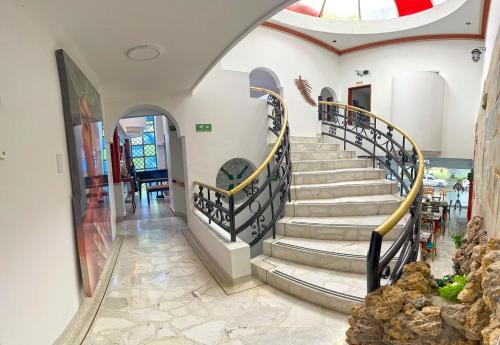 a hallway with a spiral staircase in a house at HOTEL BOUTIQUE LUXURY in Cali