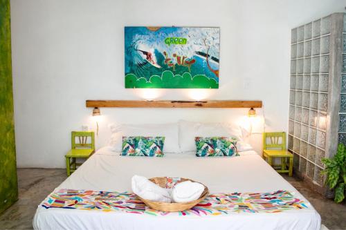 a bedroom with a bed with a basket on it at Casa Daikiri in Puerto Escondido
