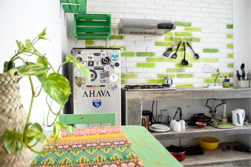 a kitchen with a refrigerator and a table in a room at Casa Daikiri in Puerto Escondido