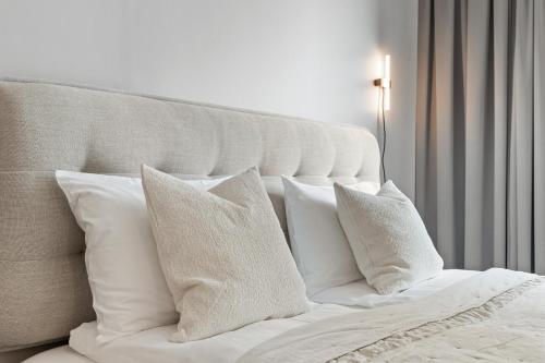 a white bed with white pillows on it at City View Lux in the City Center with Free Parking in Reykjavík