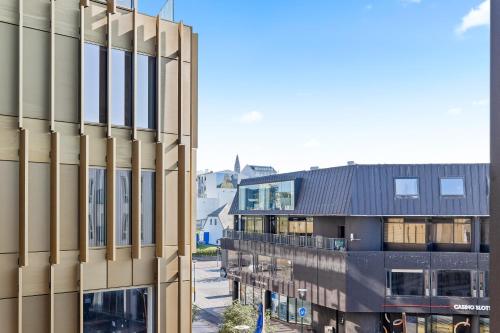 an external view of a building next to another building at City View Lux in the City Center with Free Parking in Reykjavík